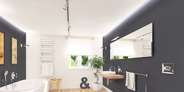 Ein modernes Badezimmer mit Schienensystem Lampen an der Decke.